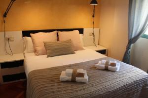 a bedroom with a bed with two towels on it at INSIDEHOME Apartments - Ático del Val in Valladolid