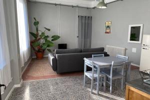 a living room with a couch and a table at Appartement indépendant dans maison de village in Saint-André-de-Sangonis