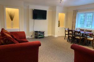 a living room with a table and a dining room at New Forest Spacious 2 bed flat in Lymington