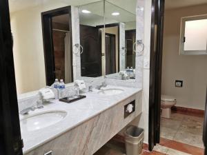 a bathroom with two sinks and a large mirror at Mirador Acapulco in Acapulco