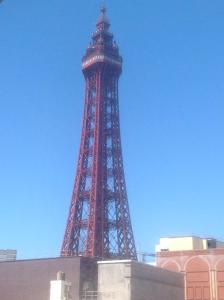 a red eiffel tower with a blue sky in the background at Myrtle house in Blackpool