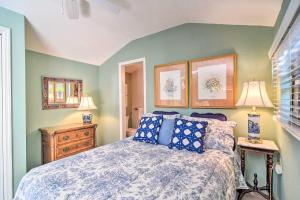 a bedroom with a bed with a blue and white comforter at Vibrant Sarasota Studio Less Than 1 Mile from the Beach! in Sarasota