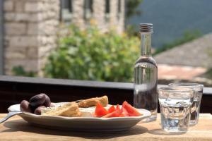 a plate of food and a bottle of water on a table at Mystic Lake in Koukkoúlion