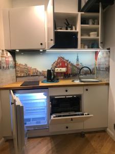 a kitchen with a counter with a microwave in it at My Place in Poznan Centrum in Poznań +12 photos