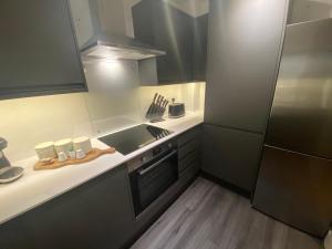 a small kitchen with a sink and a stove at City Apartment in Winchester +4 photos
