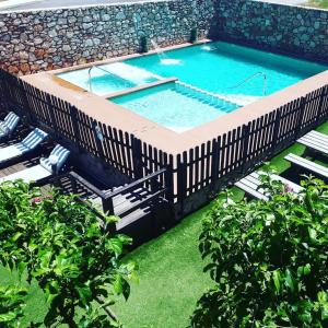 an overhead view of a swimming pool with a wooden deck at El Mirador De Ruidera in Ruidera