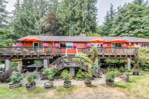 a house with a deck with plants and umbrellas at Misty Valley Inn in Forks