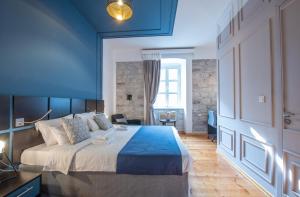 a bedroom with a large bed and a blue ceiling at Kotor Nest in Kotor