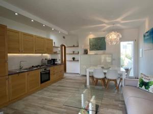a kitchen and living room with a table and a couch at R House II in Budoni