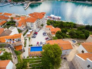 an aerial view of a house with a swimming pool at Arbiana Heritage Hotel in Rab