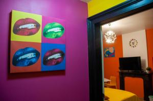 a room with a painting of lips on the wall at Vip room 209 in Trooz
