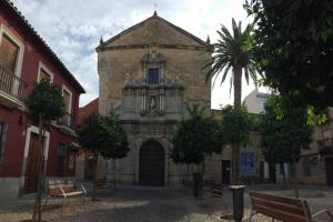 an old building with a palm tree in front of it at Casa de diseño 200m Mezquita 2 rooms & 2 bathrooms in Córdoba