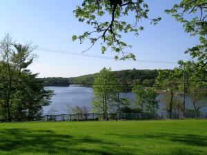 a view of a lake from a park with trees at White Rose Inns & Motel in Wisconsin Dells