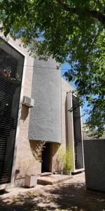 a brick building with two doors on the side of it at Belgrano Apartment con cochera in Mendoza
