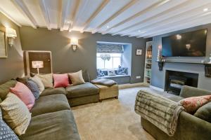 a living room with a couch and a fireplace at Bay House in Beaumaris