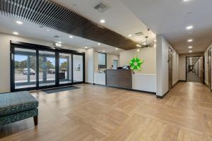 an office lobby with a couch and a counter at Extended Stay America Premier Suites - Orlando - Sanford in Sanford