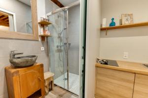 a bathroom with a glass shower with a sink at La Cour Filaterie - Suite of 30 sq m in the Annecy breakfast included in Annecy