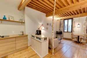 a kitchen with wooden floors and a wooden ceiling at La Cour Filaterie - Suite of 30 sq m in the Annecy breakfast included in Annecy