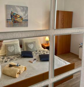 a bedroom with a bed with a towel on it at Viola Cavtat Rooms in Cavtat