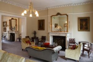 a living room filled with furniture and a fireplace at No.1 Pery Square Hotel & Spa in Limerick