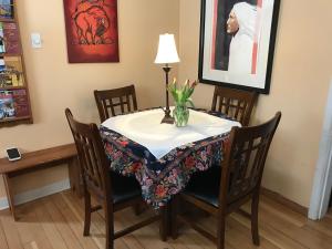 a dining room table with a vase of flowers on it at Holiday Lodge Bed and Breakfast in Banff