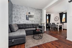 a living room with a couch and a table at Deluxe Apartments A&A in Rovinj