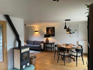 a living room with a wood stove and a table at Veerse Meer Lodge in Wolphaartsdijk