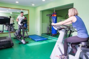a man and a woman on a treadmill in a gym at Apartments Villa Venera in Labin