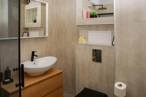 a bathroom with a sink and a mirror at Super luxurious & spacious designer apartment. in Stara Zagora