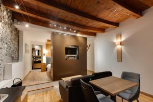 a living room with a wooden table and chairs at La Cour Filaterie - Suite au d'Annecy PDJ en option in Annecy
