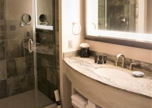 a bathroom with a sink and a shower at Hard Rock Hotel & Casino Tulsa in Tulsa