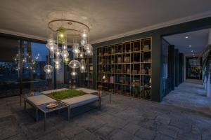 a living room with a chandelier and a table at Senhora da Rosa, Tradition & Nature Hotel in Ponta Delgada