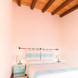 En eller flere senge i et værelse på Hotel Sa Tanca E Bore