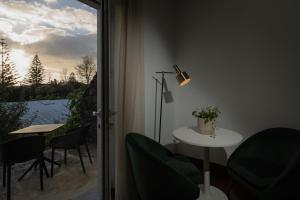 a room with a table and chairs and a window at Senhora da Rosa, Tradition & Nature Hotel in Ponta Delgada