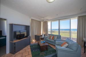 a living room with a couch and a television at Beachside Tower Apartments in Gold Coast