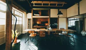 a kitchen and dining room with a table and chairs at Goonnight Hostel in Kaohsiung