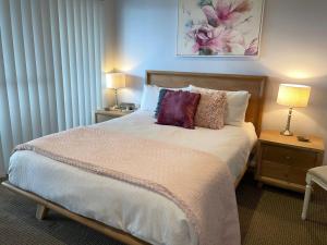 A bed or beds in a room at Footprints @ Fingal Bay