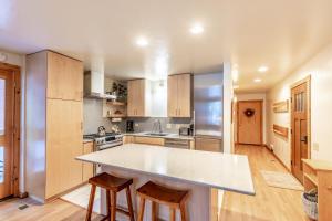 a kitchen with a large white counter top and wooden cabinets at Modern 1 bedroom in Ski Trails condo in Kingswood Estates