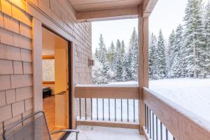 a balcony with a view of the snow covered trees at Modern 1 bedroom in Ski Trails condo in Kingswood Estates