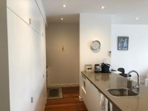 a kitchen with a sink and a counter top at C-Scape Penthouse - Cowes beach front in Cowes