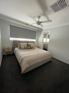 a bedroom with a bed and a ceiling fan at 63 Grigg in Koondrook