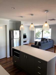 a kitchen and living room with a couch and a table at 63 Grigg in Koondrook