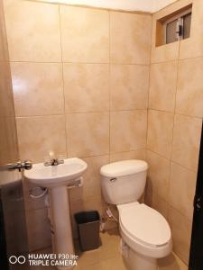 a bathroom with a toilet and a sink at Monchita's Ensenada Baja, apartments for rent. in Ensenada