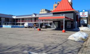 a parking lot in front of a building with a red roof at Choice Inn by the falls in Niagara Falls