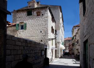 a man walking down a street in an alley at Villa Veli Varos in Split