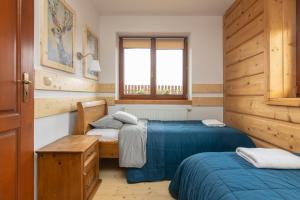 Posteľ alebo postele v izbe v ubytovaní Apartamenty Domino - Kościelisko
