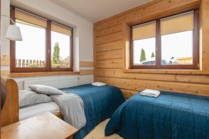 Posteľ alebo postele v izbe v ubytovaní Apartamenty Domino - Kościelisko