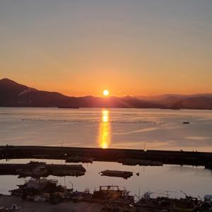 a sunset over a body of water with boats in it at Geoje Seaside Luxury Family Villa in Geoje