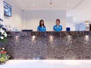 two women standing behind a counter in a lobby at Pattaya Blue Sky in Pattaya Central +12 photos