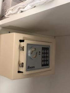a microwave hanging on a shelf in a room at La Casa del mandarino di Borgo Carbone in Locri
